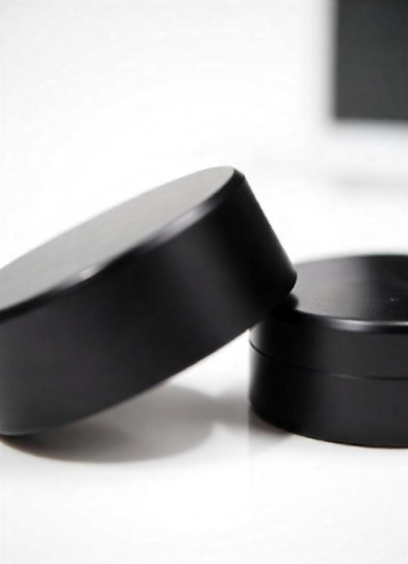 freepik__two-black-metal-rings-on-a-reflective-surface__4346